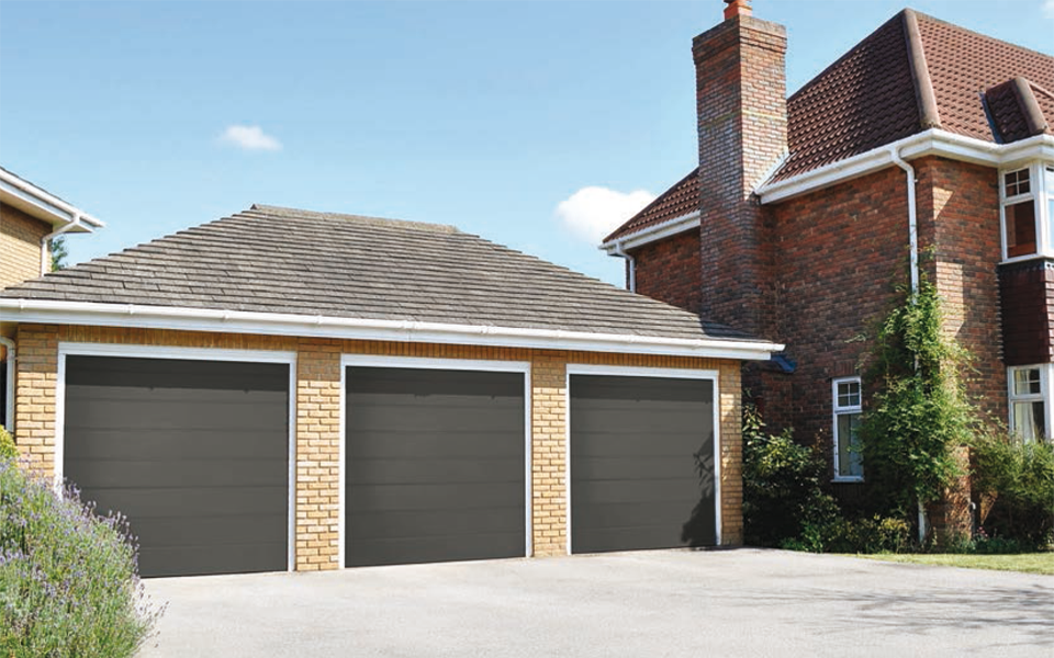 triple grey electric garage doors